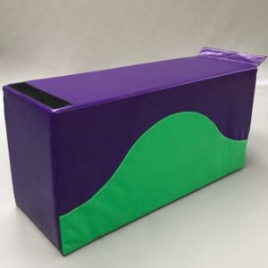 Play Creations' portable softplay retainer block in green and purple with the green sweeping halfway up the block like a hill. View from the front