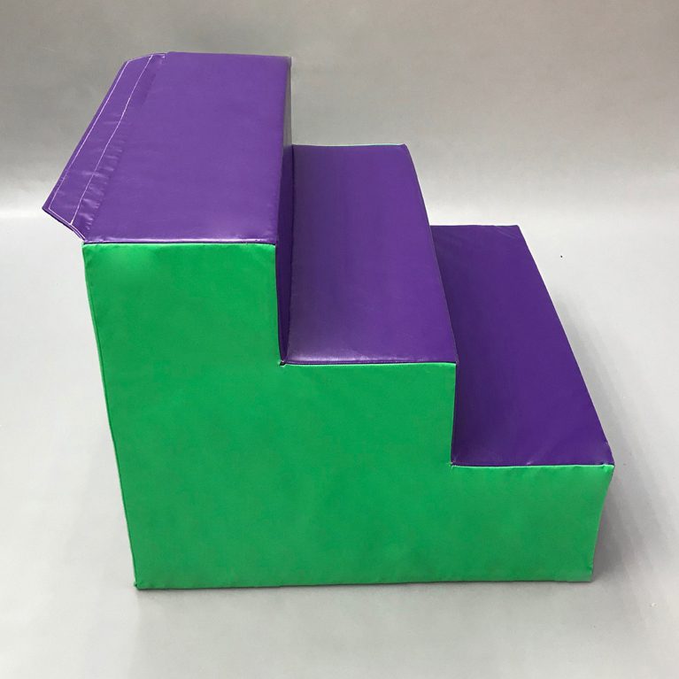 Side view of Softplay Step Block in purple and green. this is a soft 3-step feature to add to allow for climbable softplay ses.