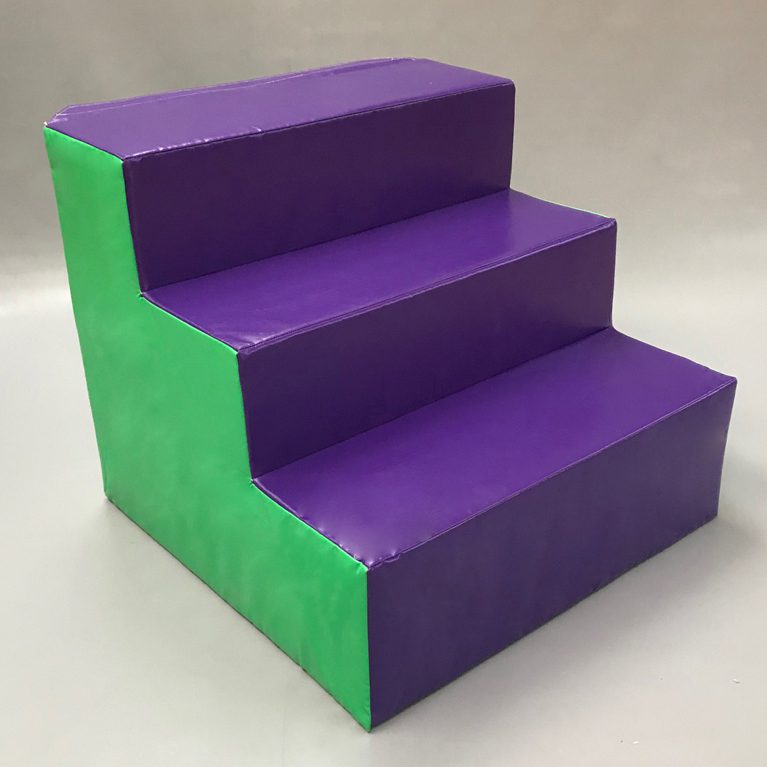 Front view of Play Creations' Softplay Step Block. The steps are purple and green and made out of foam.