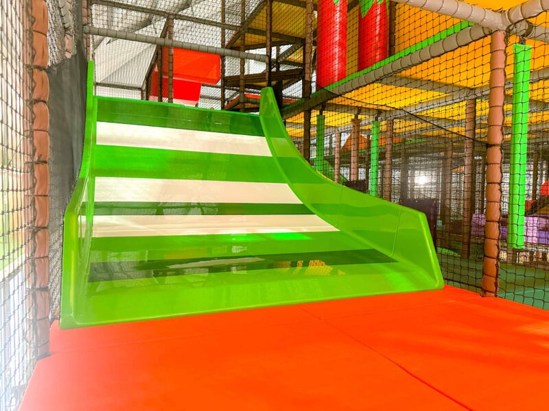 Green and white slide found at Brocksbushes indoor softplay area designed by Play Creations.