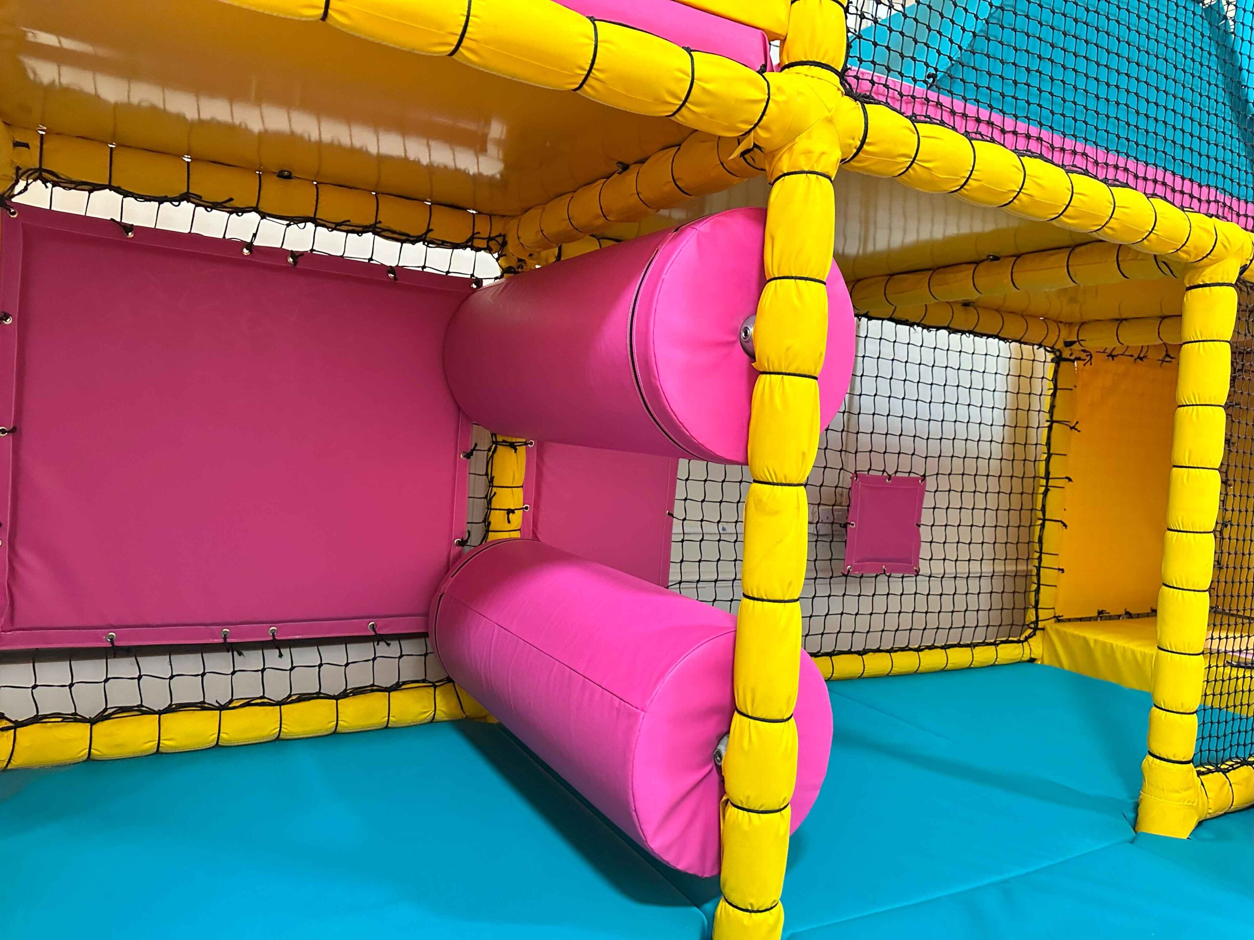 Pink horizontal rollers at Our Special Angels' indoor softplay area.