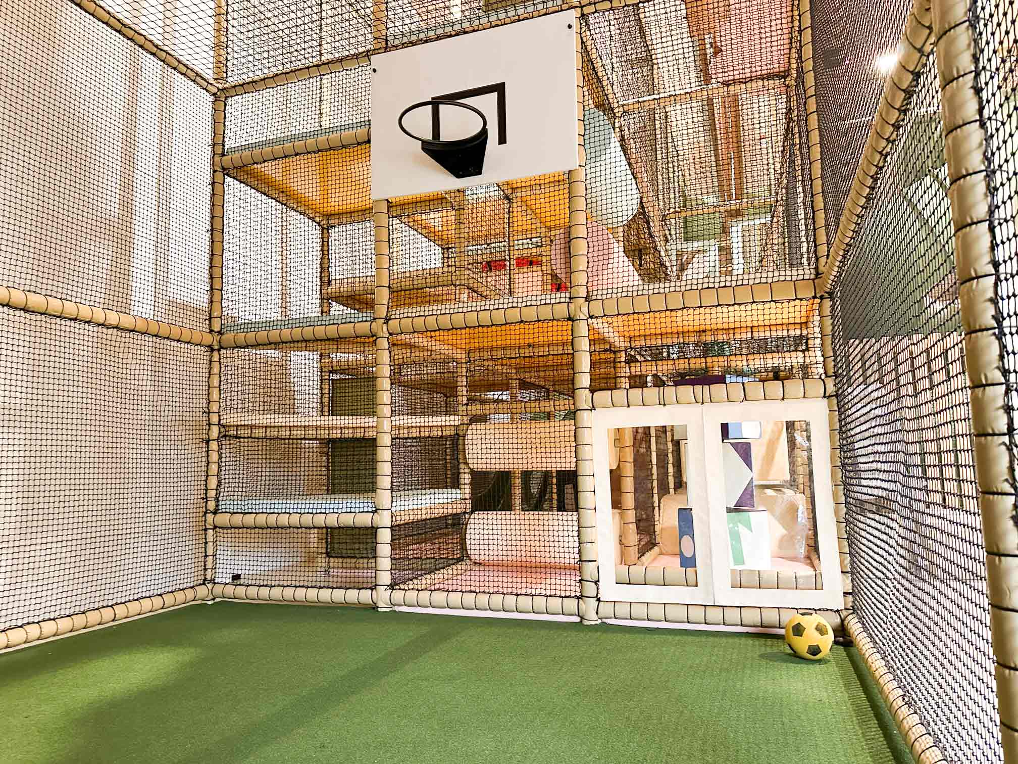 The Play Hut's indoor softplay centre's very own sports area, fit with Astro turf grass and a basketball hoop. Designed by Play Creations