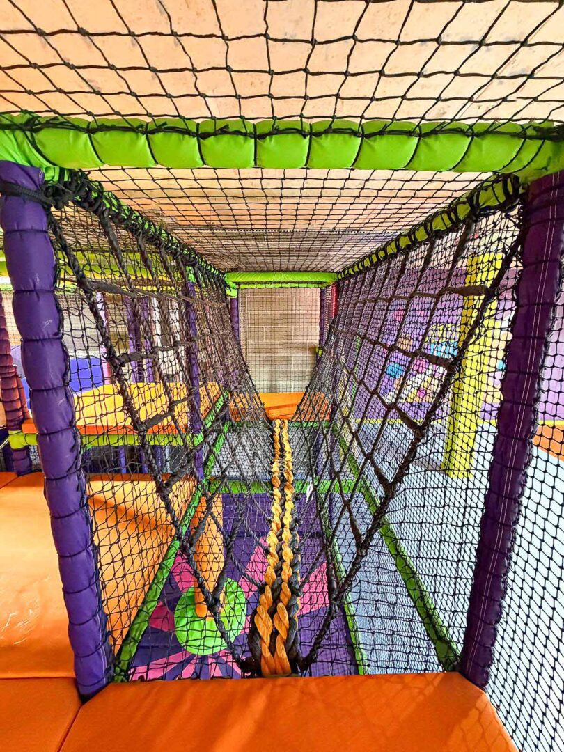 orange and black v-net bridge at Colindale's indoor softplay area at their Clip 'n' Climb.