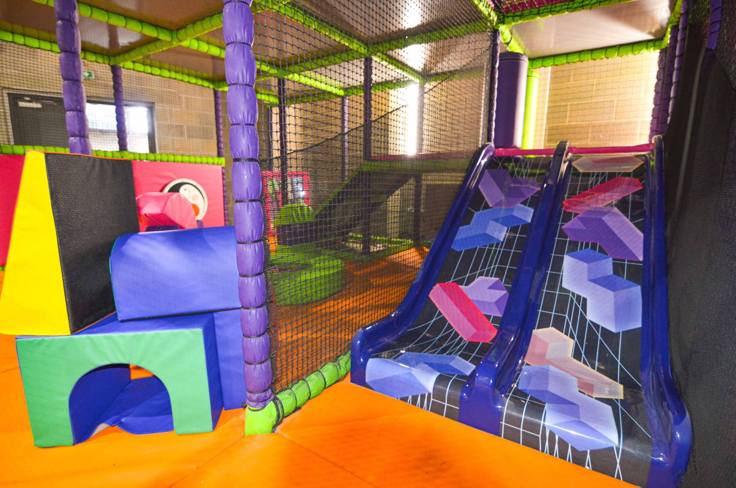 Blue and black twin lane toddler slide with a tetris pattern at Clip 'n' Climb Colindale.