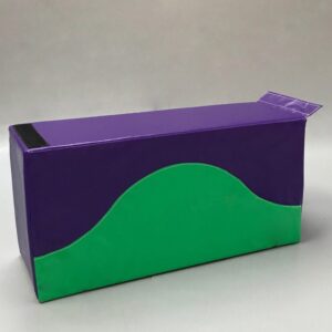 Play Creations' portable softplay retainer block in green and purple with the green sweeping halfway up the block like a hill. View from the front