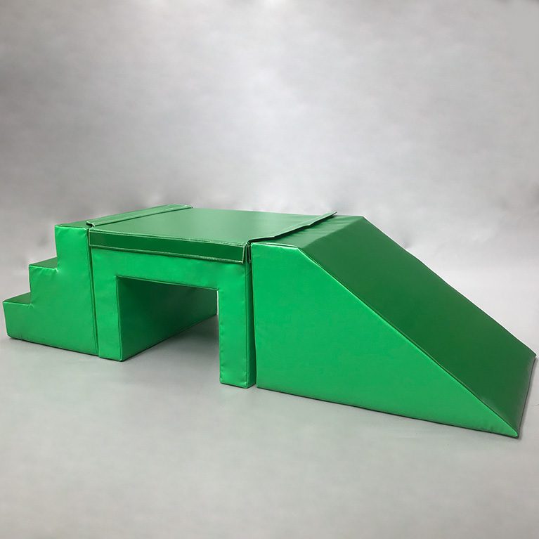 Play Creations' green softplay step, table and slide set, featuring 3 different softplay items that are connected together to form this set. View from the front