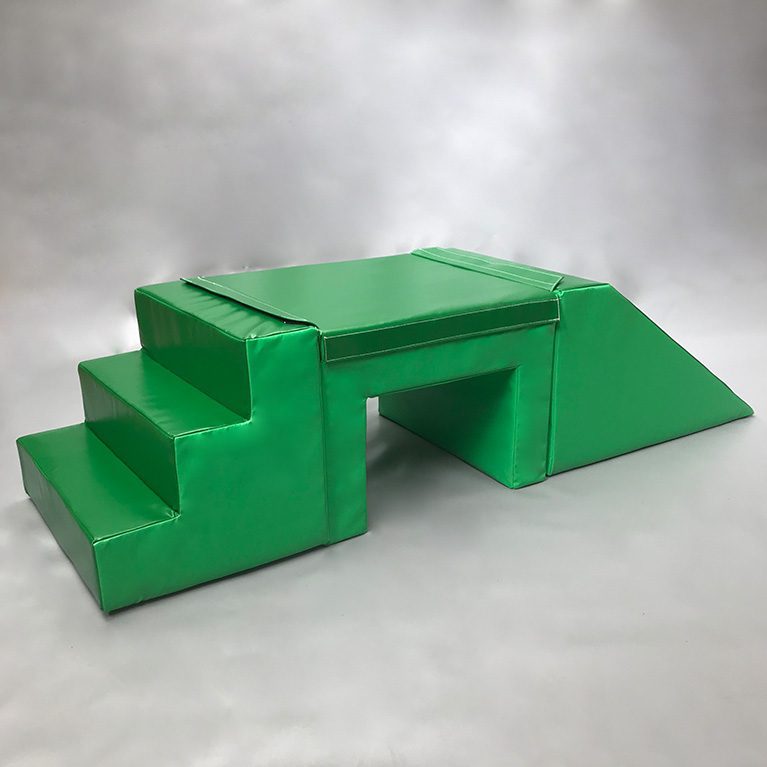 Play Creations' green softplay step, table and slide set, featuring 3 different softplay items that are connected together to form this set. View from the side