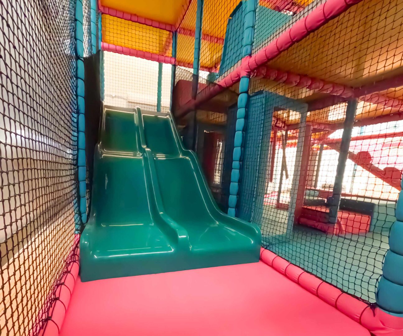 Blue twin lane slide at Rushall School's interactive indoor softplay, designed by Play Creations.