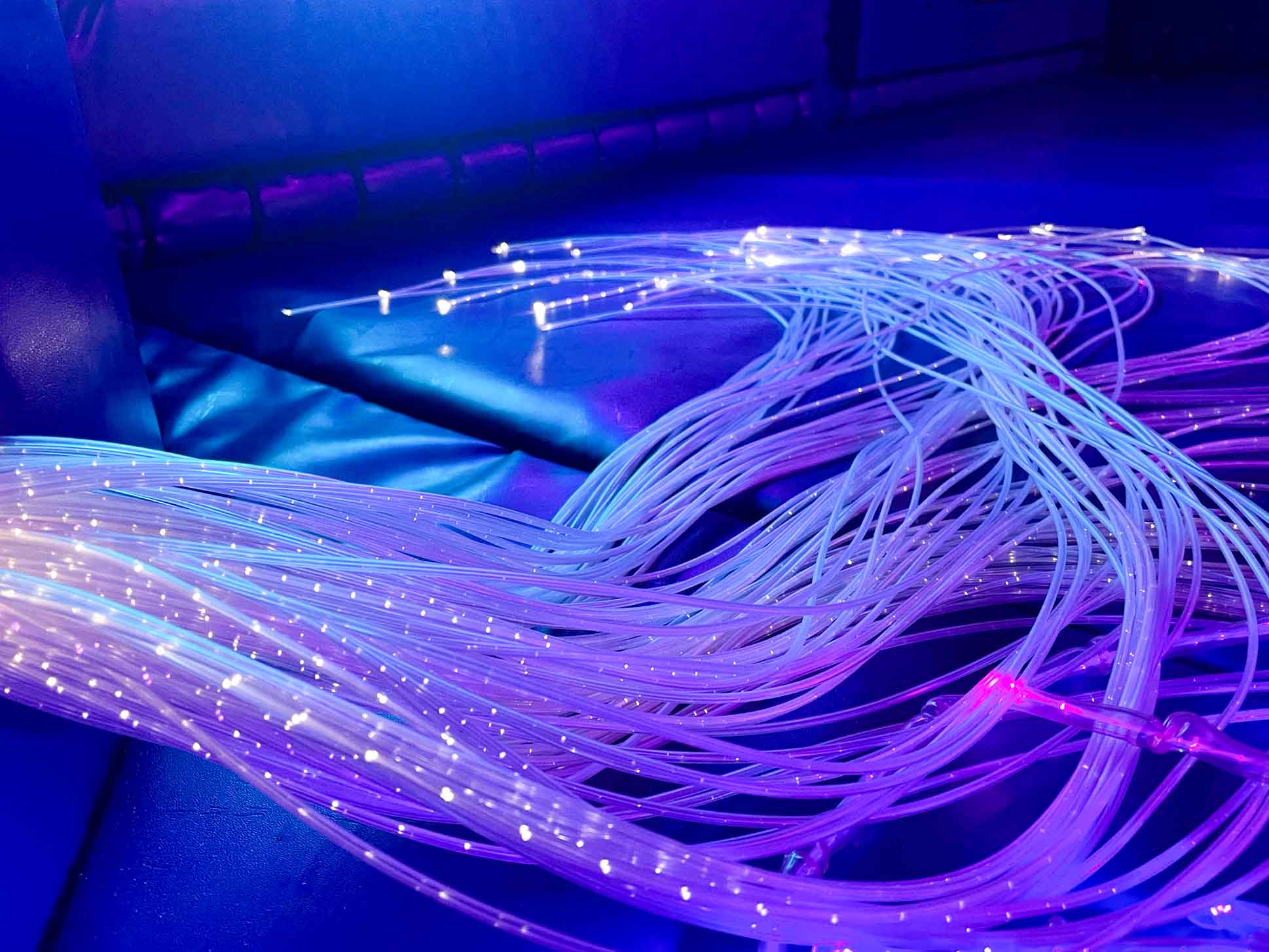 Fibre-optic strands lit up and coloured purple at St Giles Schools sensory area designed by Play Creations.