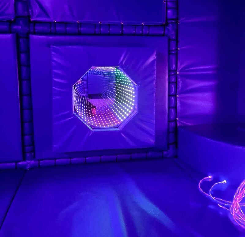 Infinity Mirror surrounded by purple vinyl on a backboard at St Giles Sensory area designed by Play Creations