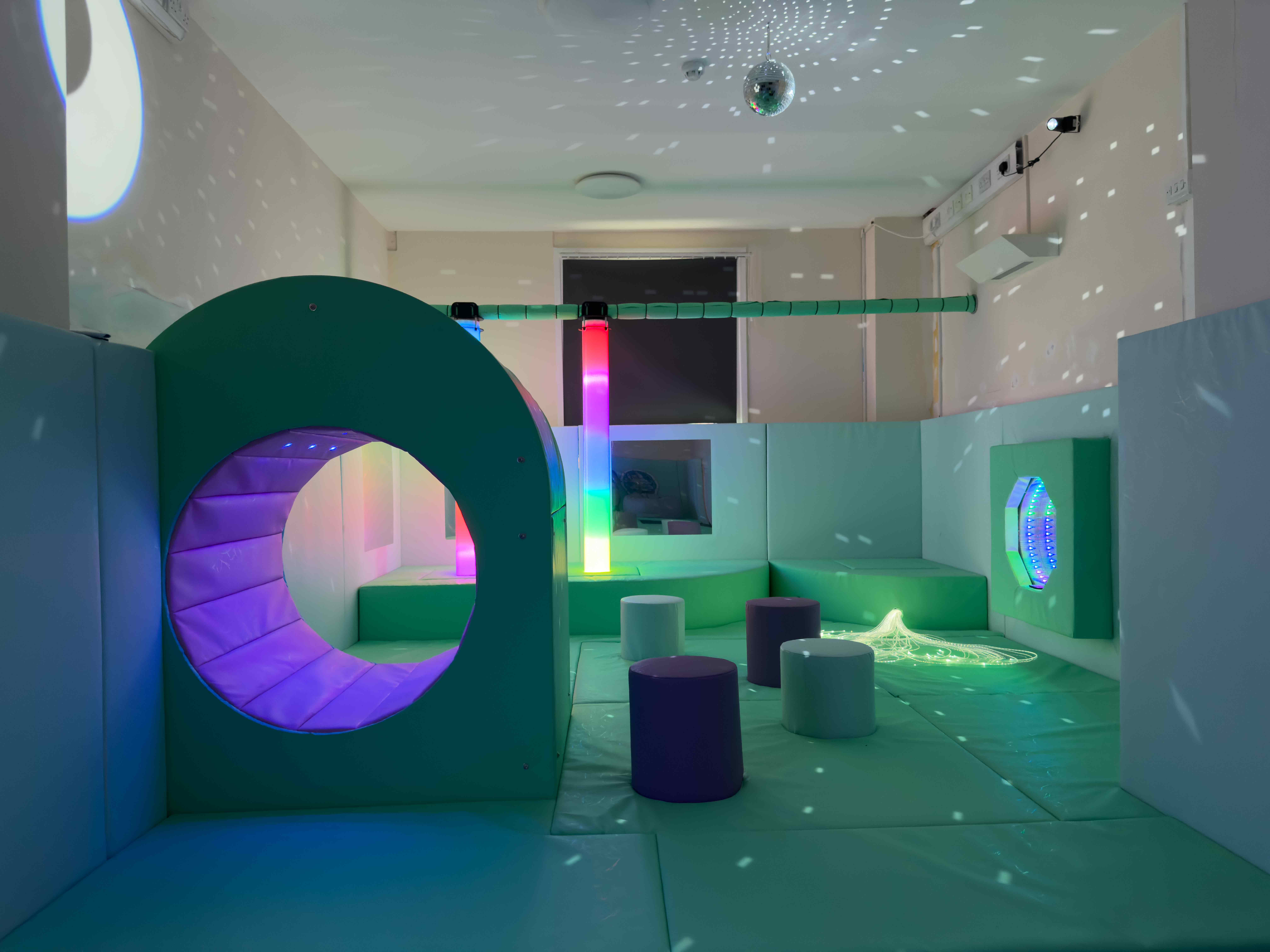 Our Special Angels Sensory room. Featuring a calming blue theme. There is a sensory nook, two LED light tubes, fibre optic strands and a LED infinity mirror.