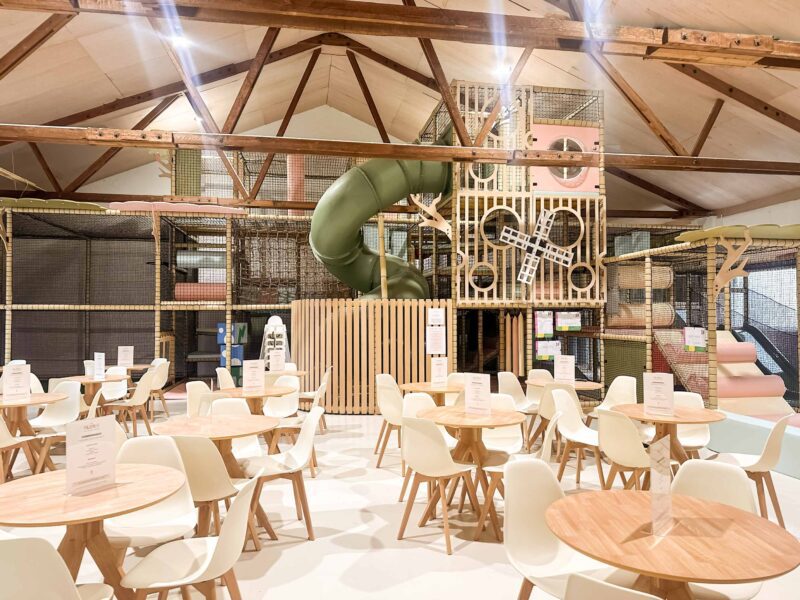 Play Hut's Multi-level indoor softplay. Scandi-Chic theme with soft green and pink colours. There's a large green tube slide and bespoke wooden decorative panelling. Designed by Play Creations